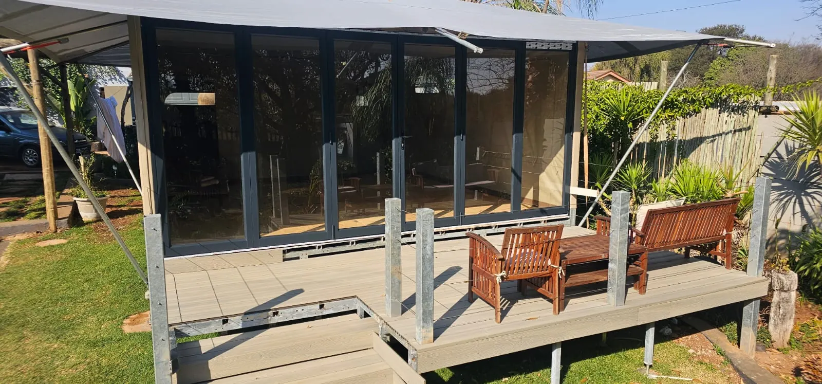 ARMIS safari tent with Vista folding glass doors opening onto a composite deck
