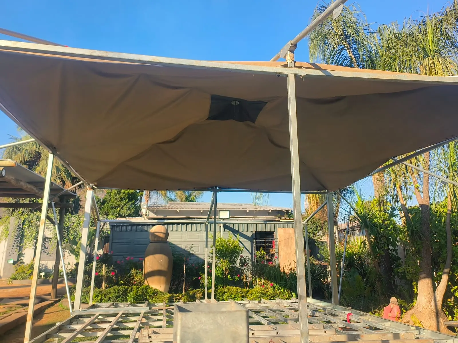 ARMIS zinc-plated steel safari tent frame with its canvas roof fitted during assembly